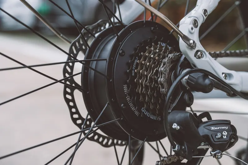 Detailed view of a bicycle wheel and gear system showcasing mechanical components