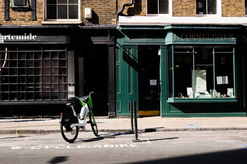 Charming vintage storefront with an electric bike parked on a quiet city street